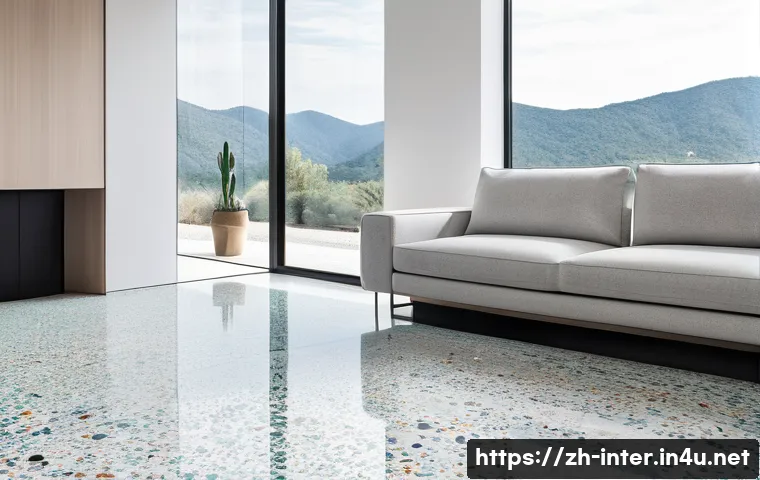 테라조 인테리어 활용법 - A modern minimalist living room featuring terrazzo flooring with small, colorful marble and glass ch...